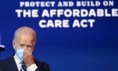 Joe Biden adjusts his mask during a discussion of healthcare and the Affordable Care Act in Wilmington, Delaware last November.