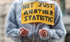 A protester with chained hands and a sign which reads "not just another statistic"