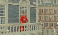 benedict cumberbatch in a red tracksuit on the balcony of a big townhouse, with papers fluttering down from the sky