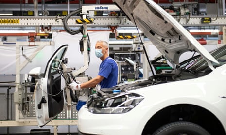 A worker wears a protective mask at the Volkswagen assembly line in Wolfsbrug after Europe’s largest car factory restarted production in April.