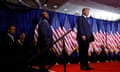 Tim Scott stands behind Donald Trump as he takes the stage during his primary night party in Nashua, New Hampshire, on 23 January. 