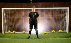 Eoin Devlin, the captain of a football team who lost 51-0, standing in football kit in a goal, with footballs behind him int he net