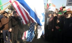 Protesters burn US and Israel flags during a pro-government rally, Mashhad, Iran, January 2018