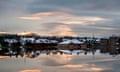 Houses are reflected in flood water at dawn in Port Elphinstone, near Aberdeen, after the River Don rose to record levels.