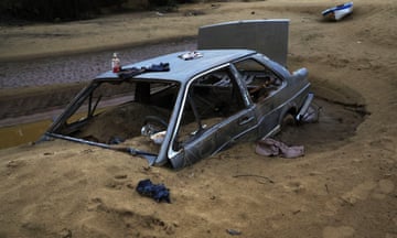 A car is left buried in Ilha Grande dos Marinheiros in Ilha Grande dos Marinheiros, Brazil.