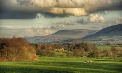 View of countryside with farmhouse in middle distance