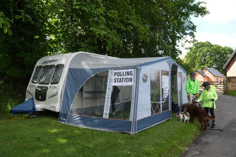 Voters arrive to cast their votes in a caravan used as a polling station in Carlton, Cambridgeshire.