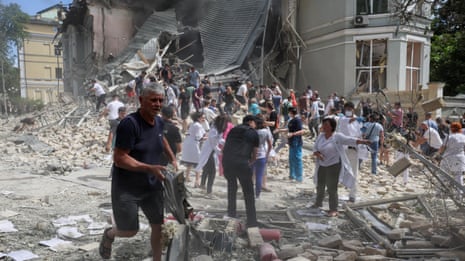 People in Kyiv dig through rubble after Russian strike hits children's hospital – video