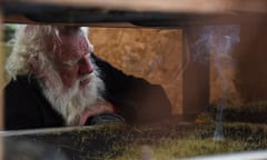 Bruce Pascoe looks into the harvest hopper at the burning chaff from seed