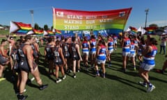 GWS and Western Bulldogs players run through a joint banner before the AFLW round four match on Friday.