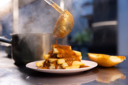 At Derrel’s, an Anglo-Indian canteen in Sydney, butter chicken sauce is poured over chunky fries.