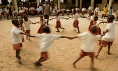 Children dance in a circle during break time at a primary school in Lagos.