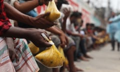 Homeless People amid coronavirus outbreak in Dhaka, Bangladesh - 20 Apr 2020<br>Mandatory Credit: Photo by Md Manik/SOPA Images/REX/Shutterstock (10619690h) A volunteer distributes food to the vulnerable people during the nationwide lockdown. On the initiative of Mr, Mohammad Mazharul Islam Sentu, President of South Kamalapur Jame Mosque, relief food has been distributed at noon every day since March 26. Homeless People amid coronavirus outbreak in Dhaka, Bangladesh - 20 Apr 2020