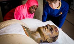 Two schoolchildren looking a Frankenstein's monster, a 1935 movie prop