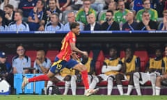 Lamine Yamal running across the pitch smiling