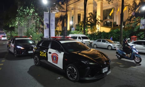 Police cars outside the Grand Hyatt Erawan hotel in Bangkok, Thailand