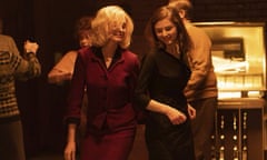 This image released by the Sundance Institute shows Anne Hathaway, left, and Thomasin McKenzie in a scene from "Eileen," which will be featured at the 2023 Sundance Film Festival. (Courtesy of Sundance Institute via AP)
