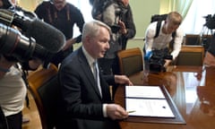 Finland’s foreign minister, Pekka Haavisto, signs the country’s petition for Nato membership.