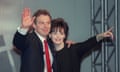 Tony Blair waving and Cherie pointing