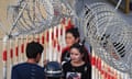 Two women pass through a secure entrance to a bazaar in Xinjiang