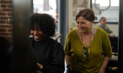 Hairdresser, Aude Livoreil-Djampou, right, laughs with one of the staff