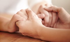 Helping a friend in need<br>Hands holding each other over a table