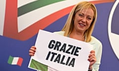 ITALY-POLITICS<br>Leader of Italian far-right party "Fratelli d'Italia" (Brothers of Italy), Giorgia Meloni reacts as she holds a placard reading "Thank You Italy" after she delivered an address at her party's campaign headquarters overnight on September 26, 2022 in Rome, after the country voted in a legislative election. - Italian far-right leader Giorgia Meloni and her allies began on September 27 what is likely to be a weeks-long process of forming a new government, with crises looming on several fronts. (Photo by Andreas SOLARO / AFP) (Photo by ANDREAS SOLARO/AFP via Getty Images)