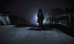 Woman crossing a bridge in the dark. From: The Hunting Ground film