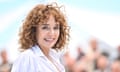 Valeria Golino in white shirt standing outside in Cannes.