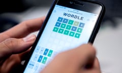 This photo illustration shows a person playing online word game "Wordle" on a mobile phone