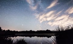 The Milky Way galaxy seen over Burton Mill Pond, thin wispy clouds, The South Downs National Park, Petworth, Sussex, UK. August. Night.<br>PEXMNK The Milky Way galaxy seen over Burton Mill Pond, thin wispy clouds, The South Downs National Park, Petworth, Sussex, UK. August. Night.