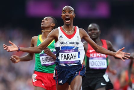 Farah celebrates as he crosses the line to win gold in the 5,000m at London 2012