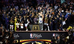 Nikola Jokić is presented with the NBA finals MVP trophy after leading the Denver Nuggets to the team’s first ever championship.