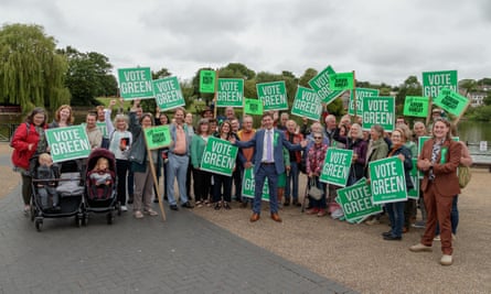 Adrian Ramsay stands in the middle of a group, many of whom are holding placards