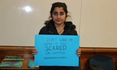 A woman holds a sign reading 'I don't want my sister to feel scared on campus #endrapeoncampus'