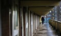 An outside corridor of flats in a high-rise building on the Falinge Estate in the UK