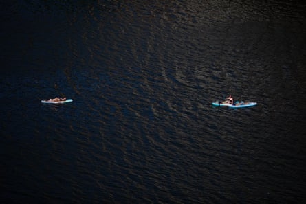 Two kayaks float in a large body of water.