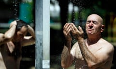 A man takes a cold shower at the Ada Ciganlija lake in Belgrade, Serbia
