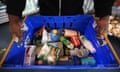 A person holds a basket with food items at Peckham Pantry in London.