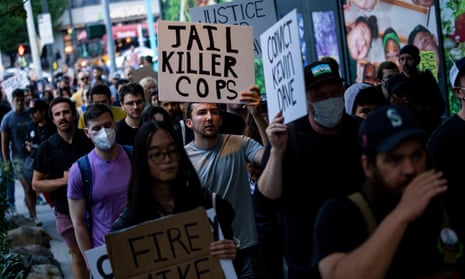 Protesters march through downtown Seattle after body camera footage was released of a Seattle police officer joking about the death of Jaahnavi Kandula, a 23-year-old woman hit and killed in January by officer Kevin Dave in a police cruiser, Thursday, Sept. 14, 2023, in Seattle. (AP Photo/Lindsey Wasson)