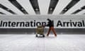 A passenger walks through the arrivals area at Terminal 5 at Heathrow airport