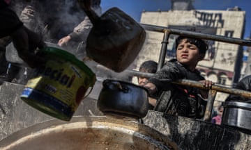 Rafah, Gaza Palestinians wait in the street for food to be distributed.