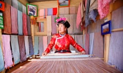 CHN: Lijang's Old Town<br>LIJIANG, CHINA - MARCH 19: A Mosuo woman weaves with a loom at her shop on March 19, 2006 in Lijiang, China. Nested deep in the cascading Himalaya Mountains, old Lijiang's winding cobbled streets and traditional architecture evokes a timeless feeling. UNESCO declared the old city of Lijiang a World Heritage site in 1997. (Photo by Chien-min Chung/Getty Images)