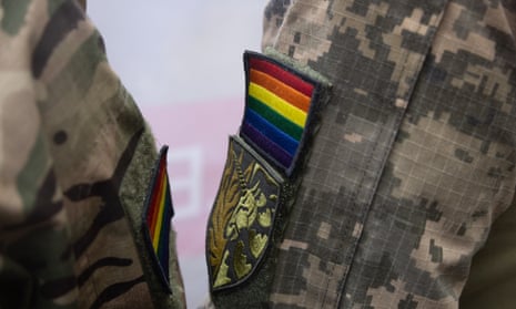 A close-up shot of a rainbow patch on the arm of a Ukrainian soldier.
