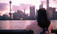 Yong Asian girl looking at the Shanghai sunset