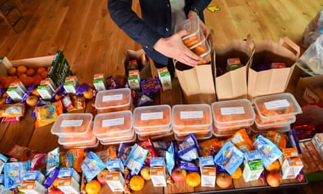 A volunteer preparing free packed lunches for children in Bristol. 