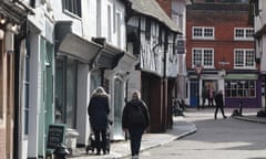 People walk up a road in Godalming, Surrey