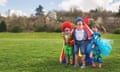 Three smiling children dressed as clowns