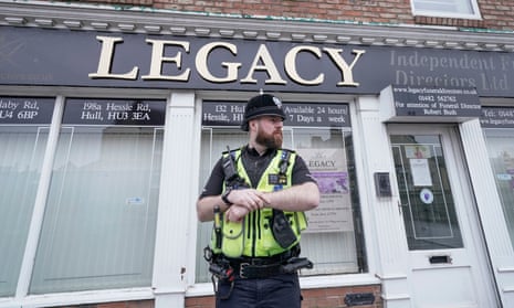 Officer outside funeral parlour