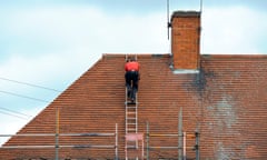 A builder on a ladder repairing a roof